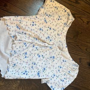 This tee is from Aeropostale. It has a floral design with buttons in the middle.
